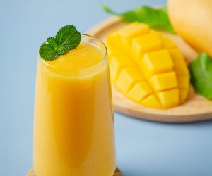 Mango juice in the glass on blue backgroud